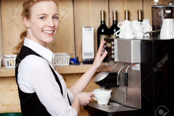 Waitress Filling Coffee In Cup From Machine At Cafe