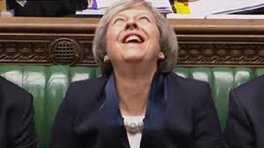 Theresa May laughing